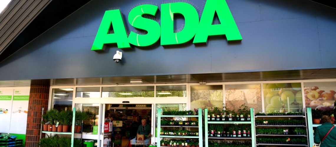 Waterlooville, UK - May 2, 2018: Asda Stores Ltd. trading as Asda, is a British supermarket retailer. The logo is prominent above the glass fronted store-front. 
Advertising, products and Sshoppers are all visible.