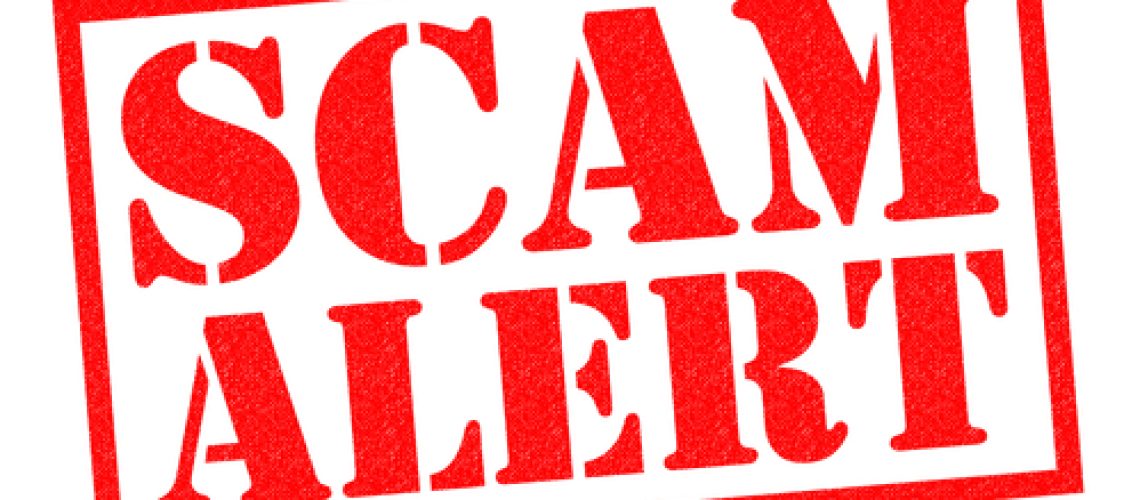 SCAM ALERT red Rubber Stamp over a white background.